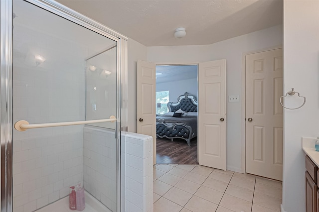 211 Aberdeen St, Stafford, TX 77477 - ensuite bathroom featuring a shower stall, tile patterned floors, and vanity