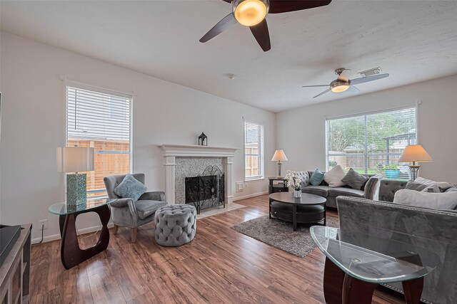 211 Aberdeen St, Stafford, TX 77477 - living room with ceiling fan, wood finished floors, and a tile fireplace