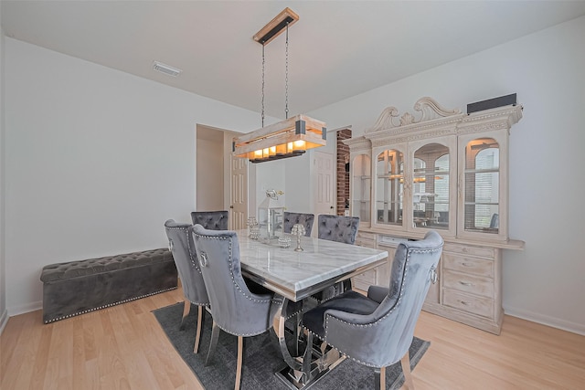 211 Aberdeen St, Stafford, TX 77477 - dining space featuring light wood finished floors and a chandelier
