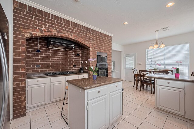211 Aberdeen St, Stafford, TX 77477 - kitchen featuring light tile patterned floors, a chandelier, a center island, white cabinets, and recessed lighting