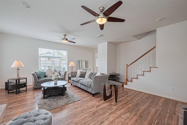 211 Aberdeen St, Stafford, TX 77477 - living room featuring wood finished floors, a ceiling fan, and stairway