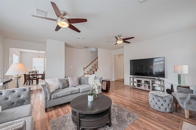 211 Aberdeen St, Stafford, TX 77477 - living area with a ceiling fan, light wood-type flooring, and stairway