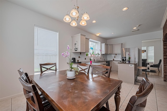 211 Aberdeen St, Stafford, TX 77477 - dining room with light tile patterned floors, a chandelier, and recessed lighting