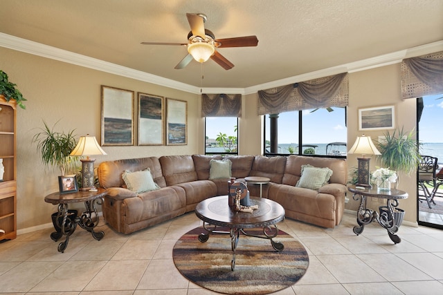 2117 Gunwale Cir, Willis, TX 77318 - living room featuring a ceiling fan, crown molding, light tile patterned flooring, and baseboards