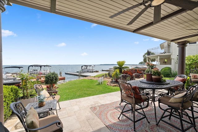 2117 Gunwale Cir, Willis, TX 77318 - view of patio with a ceiling fan, a water view, outdoor dining space, and a boat dock
