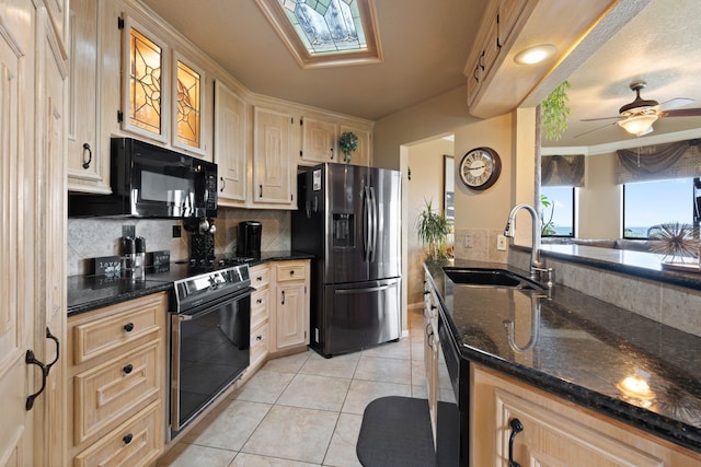 2117 Gunwale Cir, Willis, TX 77318 - kitchen with stainless steel fridge with ice dispenser, black microwave, a sink, electric range, and light tile patterned floors