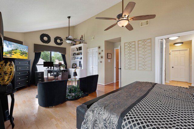 2117 Gunwale Cir, Willis, TX 77318 - bedroom with light wood-type flooring, a desk, high vaulted ceiling, and a ceiling fan