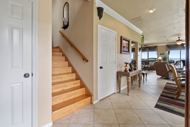 2117 Gunwale Cir, Willis, TX 77318 - stairway with a textured ceiling, ornamental molding, tile patterned floors, and a ceiling fan