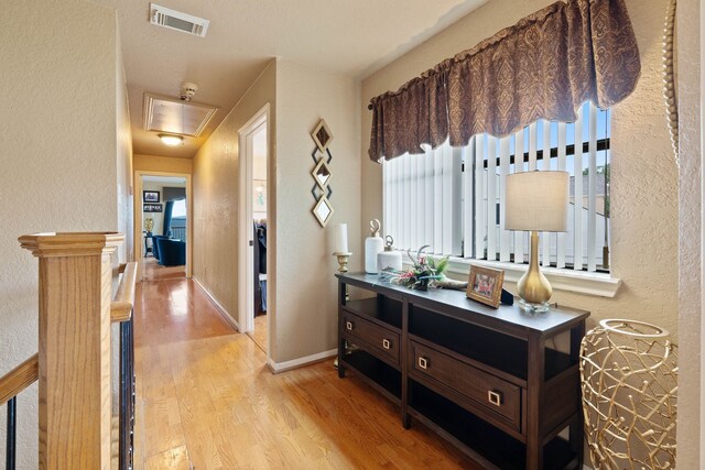 2117 Gunwale Cir, Willis, TX 77318 - hall with wood finished floors, a textured wall, and baseboards