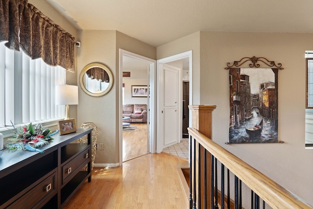 2117 Gunwale Cir, Willis, TX 77318 - hallway with light wood-style floors, baseboards, and plenty of natural light