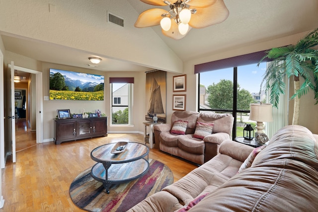 2117 Gunwale Cir, Willis, TX 77318 - living area featuring light wood-type flooring, a ceiling fan, vaulted ceiling, and baseboards
