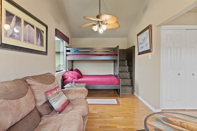 2117 Gunwale Cir, Willis, TX 77318 - bedroom featuring lofted ceiling, wood finished floors, a closet, baseboards, and ceiling fan