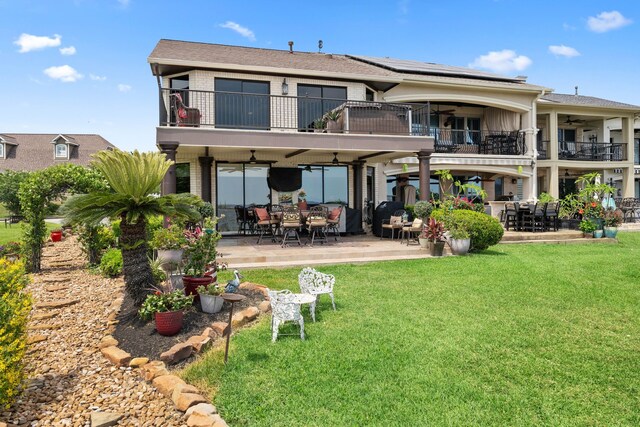 2117 Gunwale Cir, Willis, TX 77318 - rear view of property featuring a balcony, a ceiling fan, and a lawn