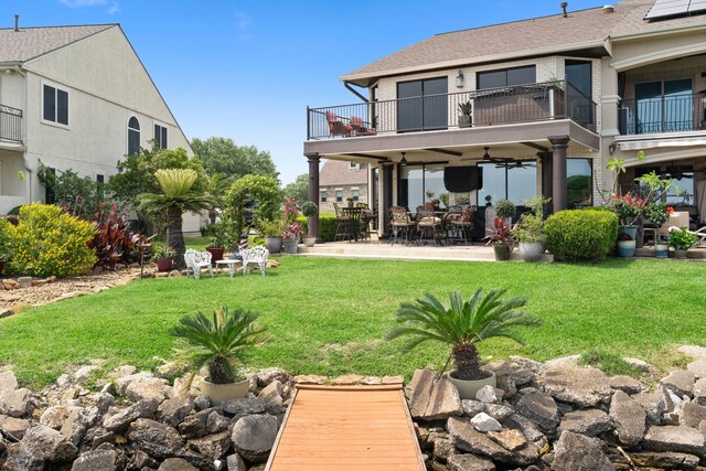 2117 Gunwale Cir, Willis, TX 77318 - back of property featuring a balcony, a patio, a yard, ceiling fan, and roof with shingles
