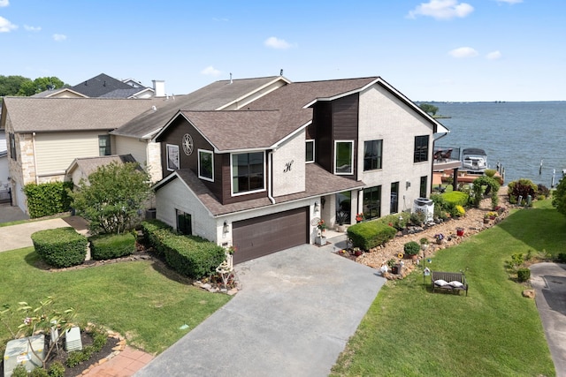 2117 Gunwale Cir, Willis, TX 77318 - view of front of house featuring driveway, a garage, roof with shingles, a front yard, and a water view