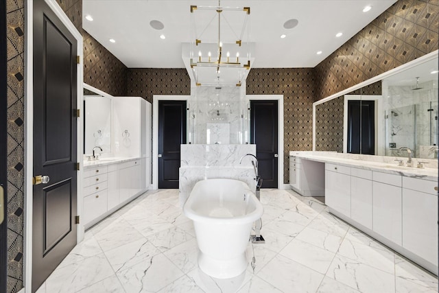 2221 Welch St Unit 601, Houston, TX 77019 - bathroom with a marble finish shower, two vanities, wallpapered walls, a freestanding tub, and a chandelier