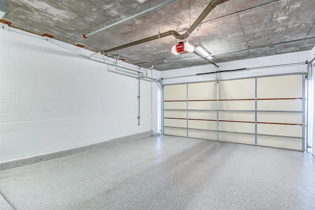 2221 Welch St Unit 601, Houston, TX 77019 - garage with a garage door opener and baseboards
