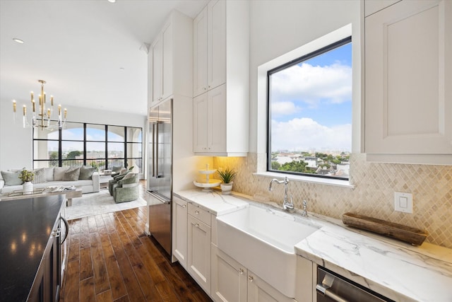 2221 Welch St Unit 601, Houston, TX 77019 - kitchen featuring stainless steel appliances, a sink, dark wood-style flooring, open floor plan, and white cabinets