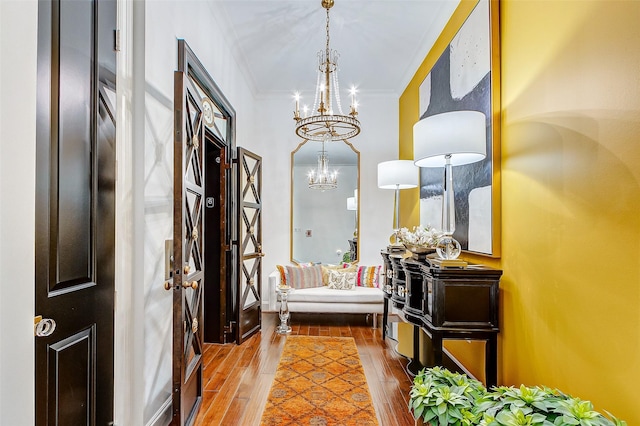 2221 Welch St Unit 601, Houston, TX 77019 - entrance foyer featuring a chandelier, hardwood / wood-style flooring, and crown molding