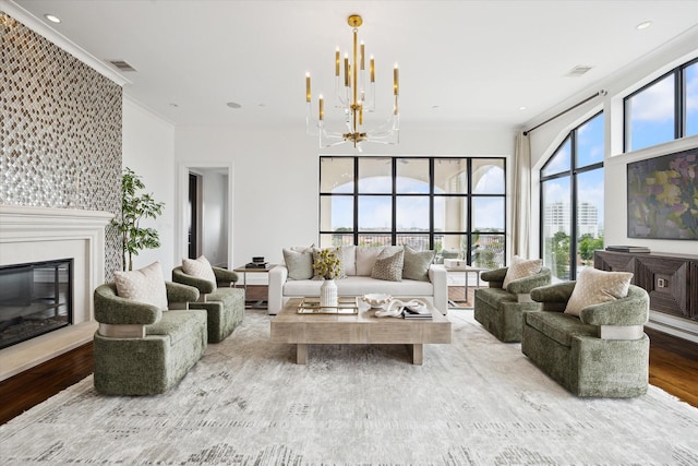2221 Welch St Unit 601, Houston, TX 77019 - living room with a chandelier, crown molding, wood finished floors, and a glass covered fireplace