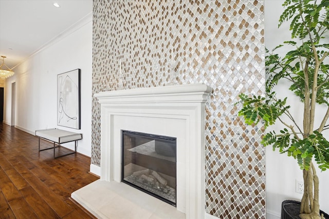 2221 Welch St Unit 601, Houston, TX 77019 - detailed view of crown molding, wood finished floors, a glass covered fireplace, baseboards, and an accent wall