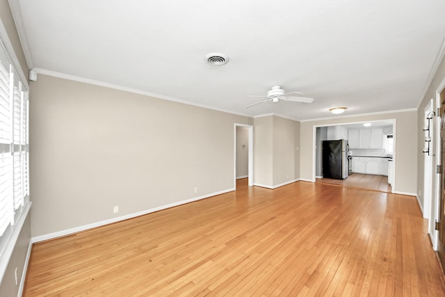 1831 Watercrest Dr, Houston, TX 77008 - unfurnished living room with a ceiling fan, light wood-style flooring, baseboards, and crown molding