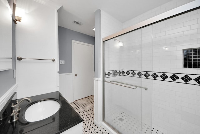 1831 Watercrest Dr, Houston, TX 77008 - bathroom with wainscoting, a shower stall, and vanity
