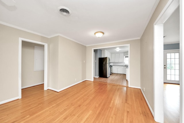 1831 Watercrest Dr, Houston, TX 77008 - unfurnished living room featuring light wood-style floors, crown molding, and baseboards