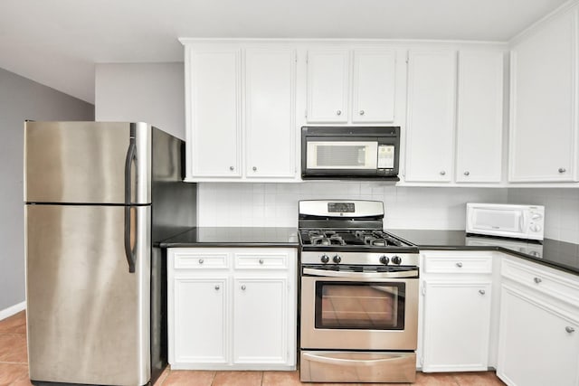 1831 Watercrest Dr, Houston, TX 77008 - kitchen featuring stainless steel appliances, dark countertops, backsplash, white cabinets, and light tile patterned floors