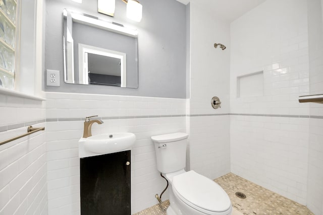 1831 Watercrest Dr, Houston, TX 77008 - bathroom with tile walls, tiled shower, vanity, toilet, and wainscoting