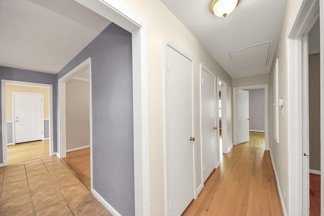 1831 Watercrest Dr, Houston, TX 77008 - hallway with attic access, light wood finished floors, and baseboards