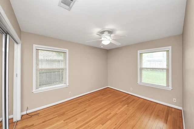 1831 Watercrest Dr, Houston, TX 77008 - unfurnished bedroom with baseboards, multiple windows, a closet, and light wood finished floors
