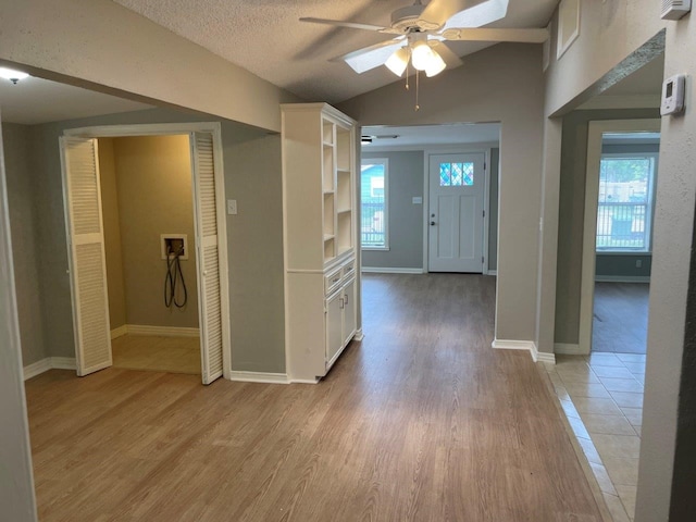 5311 Gano St, Houston, TX 77009 - foyer entrance featuring ceiling fan, light wood-type flooring, plenty of natural light, baseboards, and a textured ceiling