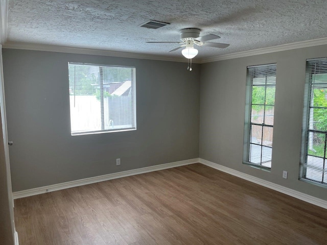 5311 Gano St, Houston, TX 77009 - spare room with wood finished floors, ceiling fan, a textured ceiling, crown molding, and baseboards