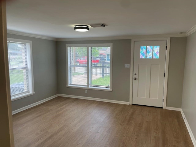 5311 Gano St, Houston, TX 77009 - foyer with ornamental molding, wood finished floors, and baseboards