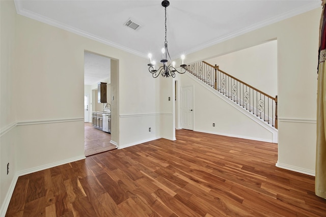 3006 Nickleby Ct, Katy, TX 77494 - unfurnished dining area with a chandelier, wood finished floors, crown molding, baseboards, and stairway