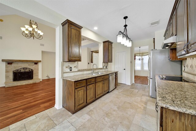 3006 Nickleby Ct, Katy, TX 77494 - kitchen featuring a chandelier, appliances with stainless steel finishes, a sink, and stone tile flooring