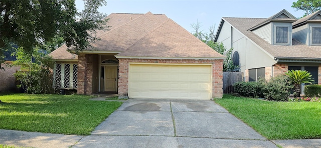 1538 Ridgebriar Dr, Houston, TX 77014 - view of front of house featuring a front yard, concrete driveway, an attached garage, and a shingled roof