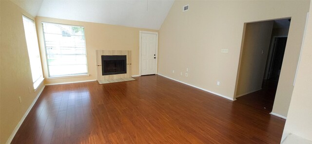 1538 Ridgebriar Dr, Houston, TX 77014 - unfurnished living room with lofted ceiling, dark wood-type flooring, and a tile fireplace