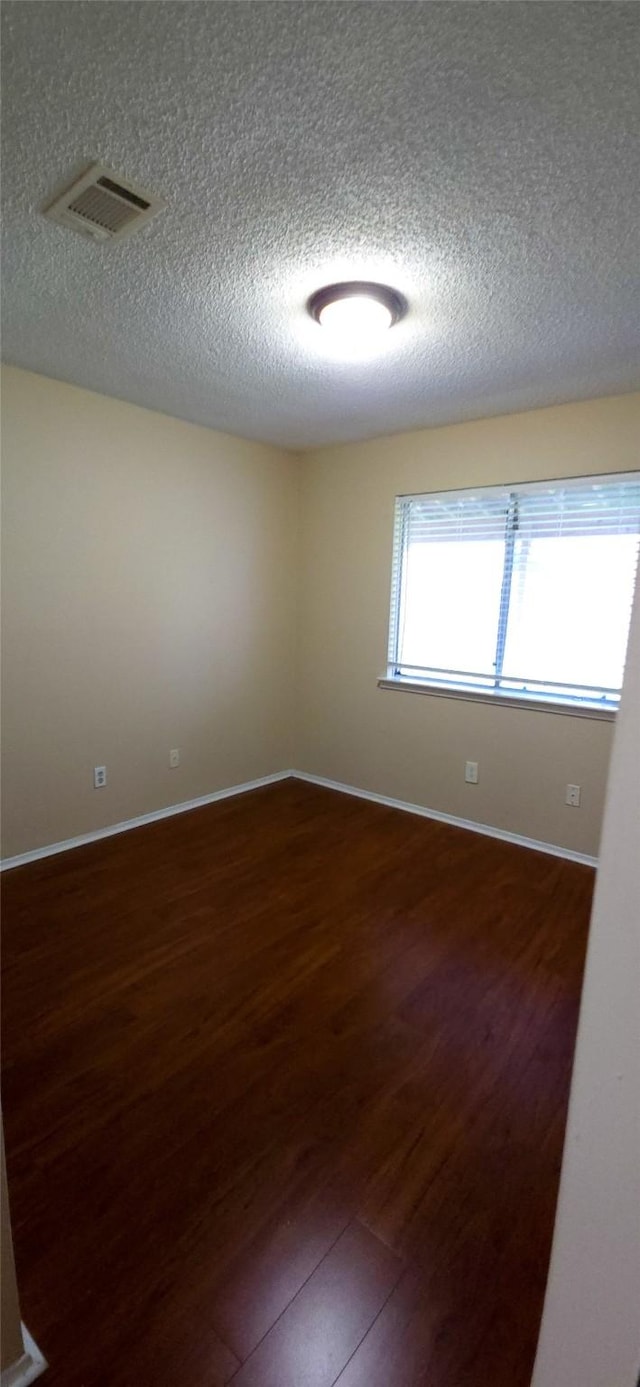 1538 Ridgebriar Dr, Houston, TX 77014 - empty room with a textured ceiling and wood finished floors