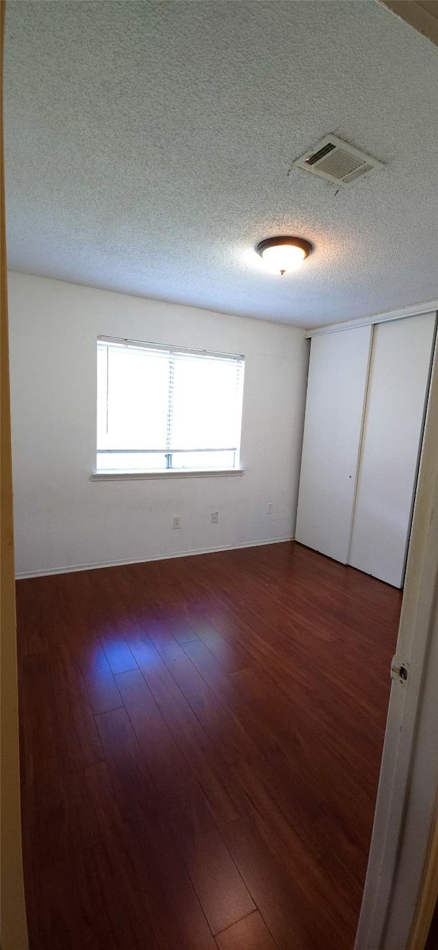 1538 Ridgebriar Dr, Houston, TX 77014 - spare room with healthy amount of natural light, wood finished floors, and a textured ceiling