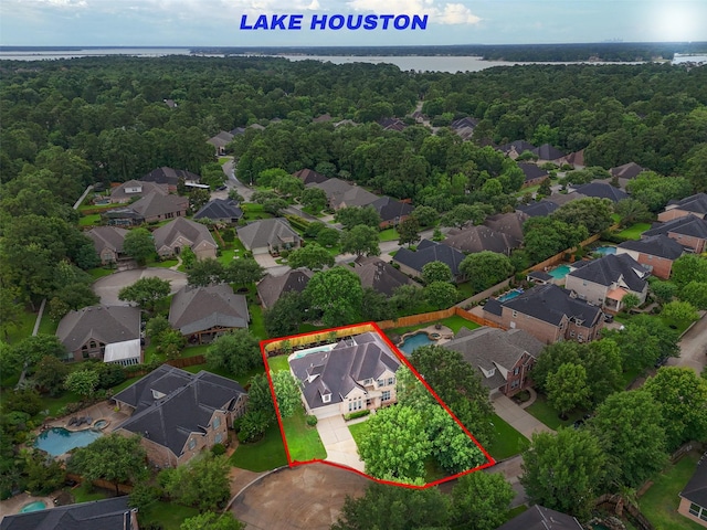6014 Shady Birch Holw, Houston, TX 77345 - aerial view of residential area featuring a forest, property parcel outlined, and a nearby body of water