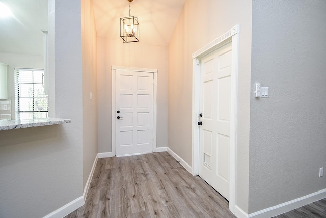 2012 Hickory Glen Dr, Missouri City, TX 77489 - foyer with a chandelier, light wood-style flooring, and baseboards