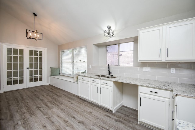 2012 Hickory Glen Dr, Missouri City, TX 77489 - kitchen featuring a sink, decorative backsplash, lofted ceiling, french doors, and white cabinets