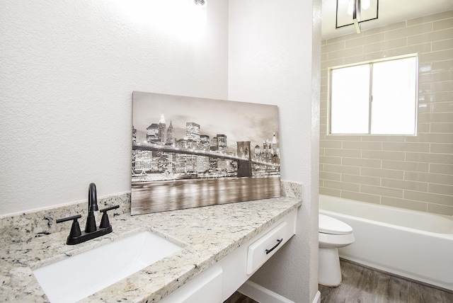 2012 Hickory Glen Dr, Missouri City, TX 77489 - bathroom with toilet, wood finished floors, vanity,  shower combination, and a textured wall