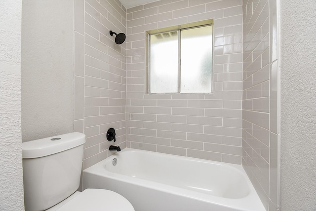 2012 Hickory Glen Dr, Missouri City, TX 77489 - bathroom with toilet, a textured wall, and washtub / shower combination