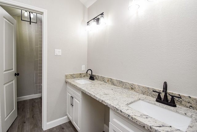 2012 Hickory Glen Dr, Missouri City, TX 77489 - full bathroom with double vanity, wood finished floors, and baseboards