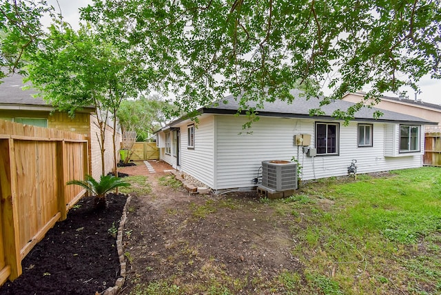 2012 Hickory Glen Dr, Missouri City, TX 77489 - rear view of property with a fenced backyard, central AC, and a shingled roof