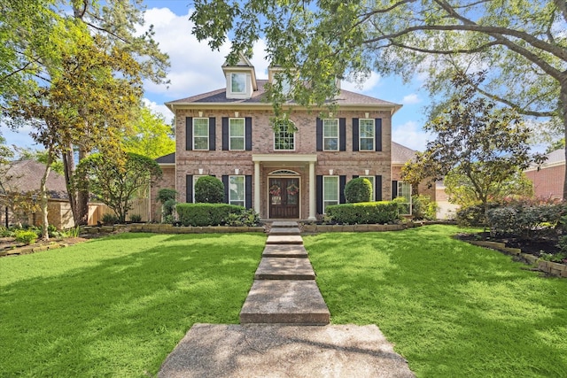 1615 Lake Wilderness Ln, Kingwood, TX 77345 - colonial home with brick siding and a front lawn