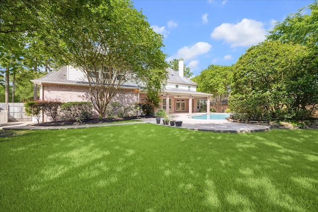 1615 Lake Wilderness Ln, Kingwood, TX 77345 - rear view of house featuring a chimney, a patio area, brick siding, and french doors
